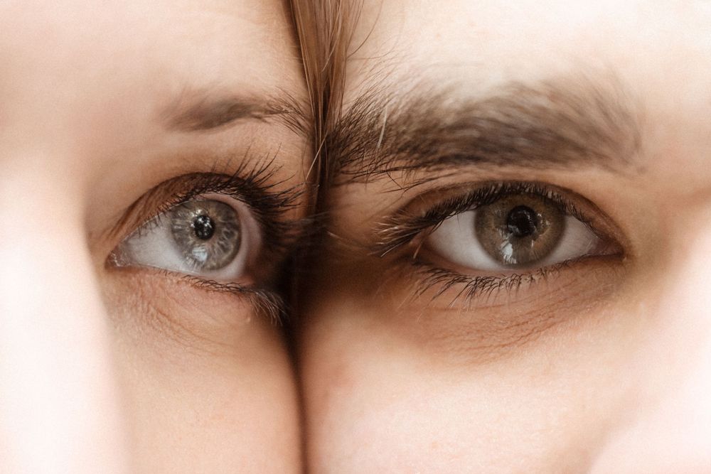 Close up macro shot of two eyes side by side showing different eye colors.