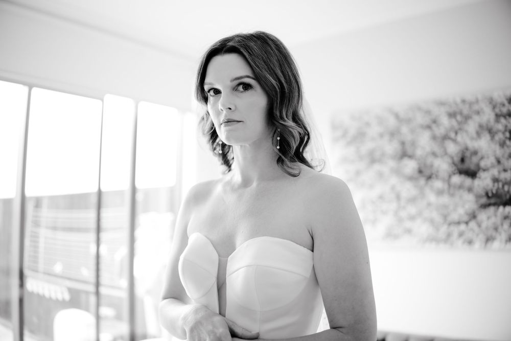 Black and white portrait shots of bride getting ready for wedding ceremony.