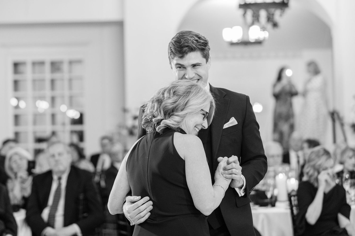 A collage of black and white photos showing couples dancing together at a formal wedding reception.