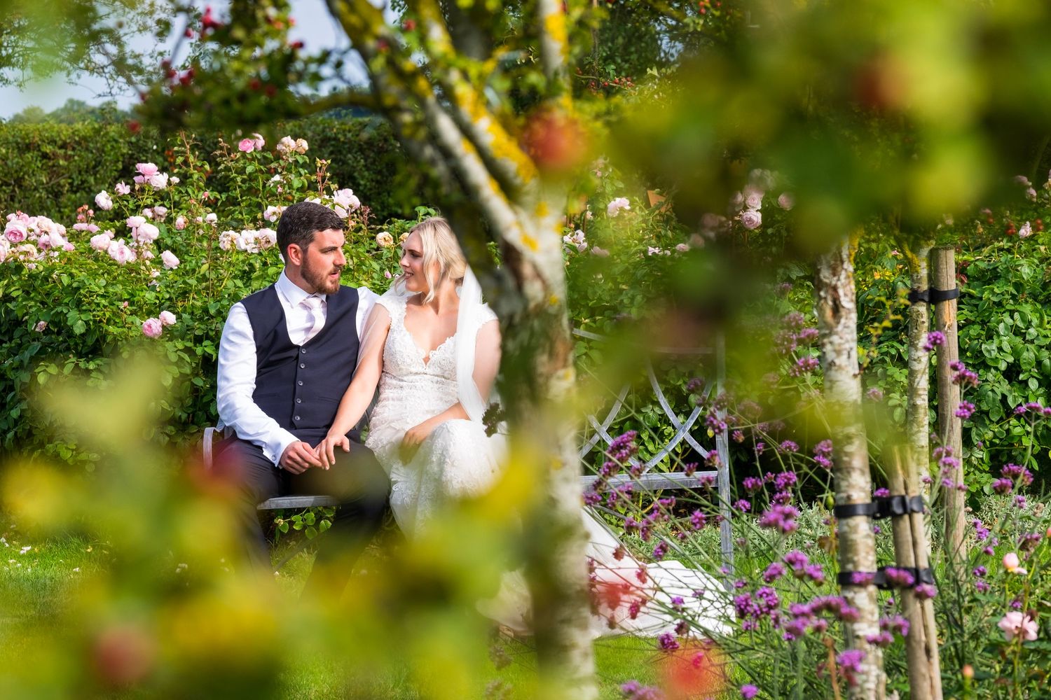 Reportage detail shot of bride and groom having a quiet moment in a secluded garden
