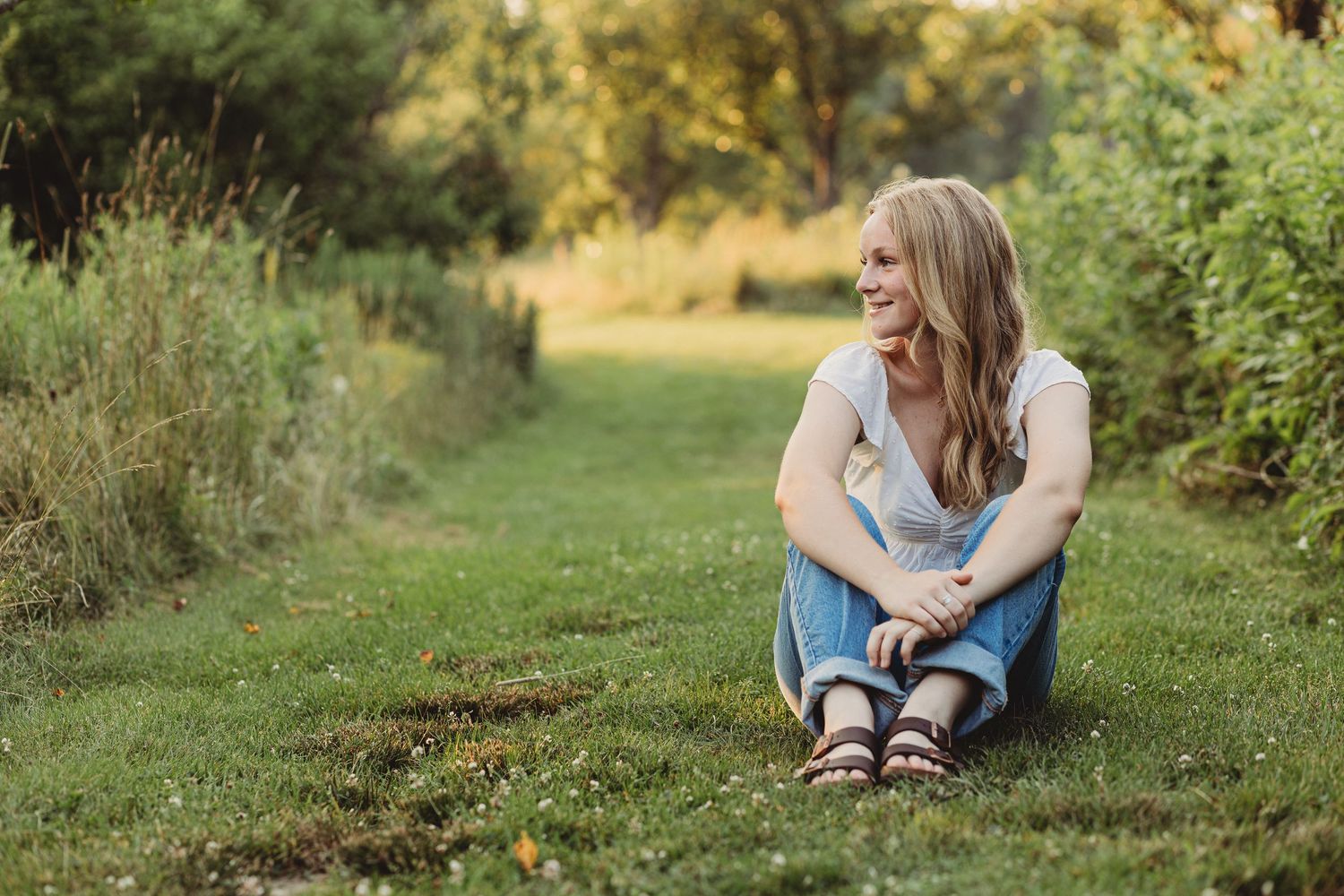 Professional senior photo of a girl in the grass