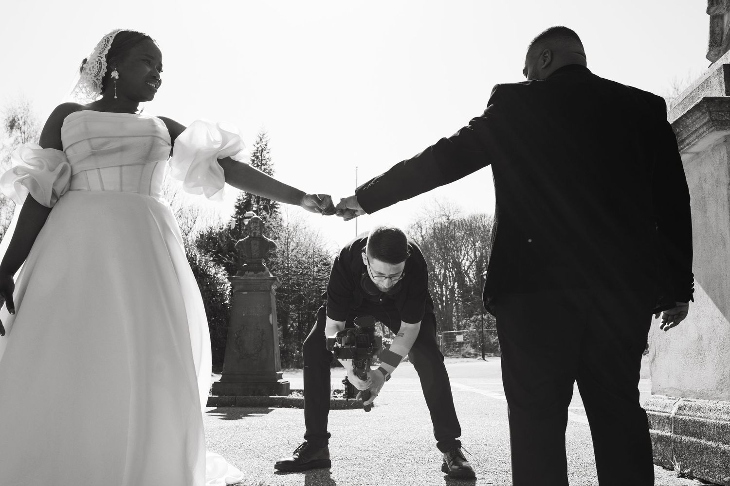 Black and white wedding photos showing celebratory moments between wedding party members.