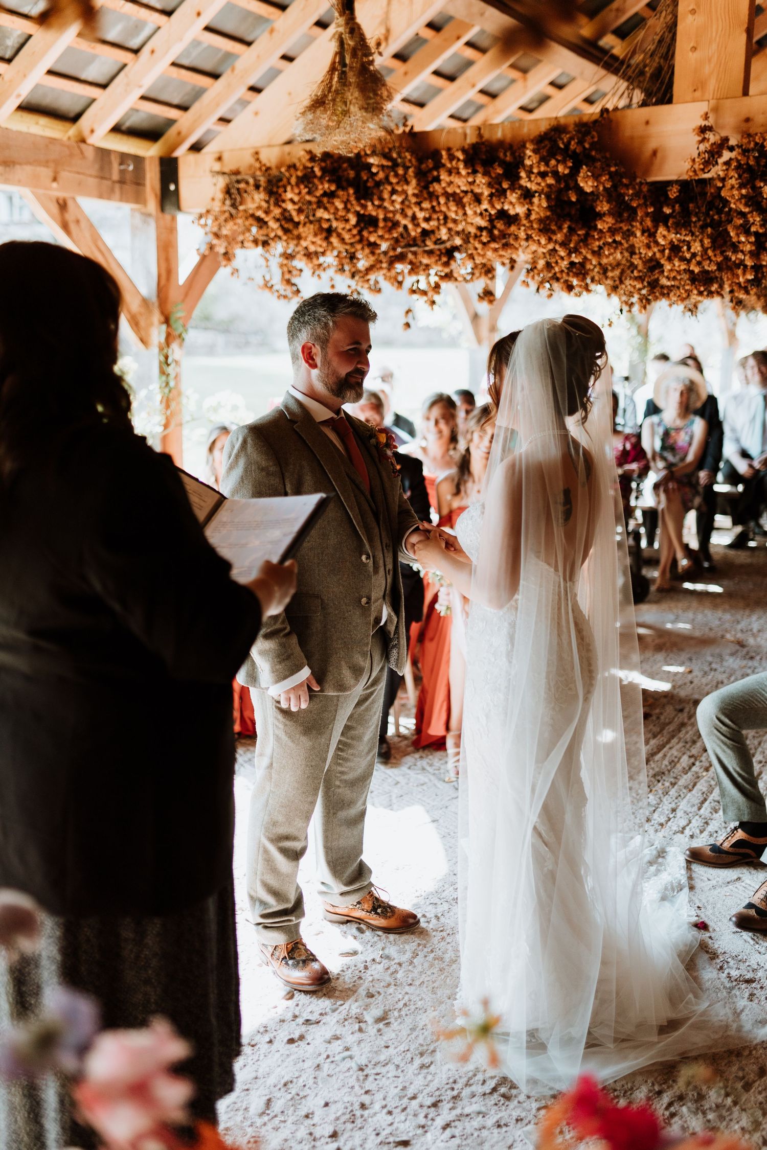 A romantic first dance sequence at a rustic outdoor wedding venue decorated with string lights and floral arrangements.