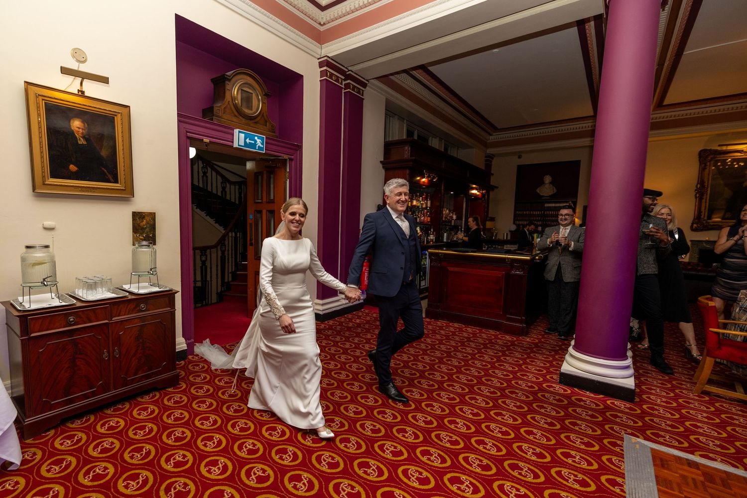 bride and groom enter the wedding reception before their first dance. the Athenaeum Liverpool City Centre wedding photography.