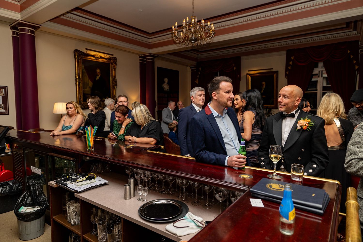 guests at the bar ordering drinks during the Athenaeum wedding reception. Stuart Morris Liverpool City Centre wedding Photographer