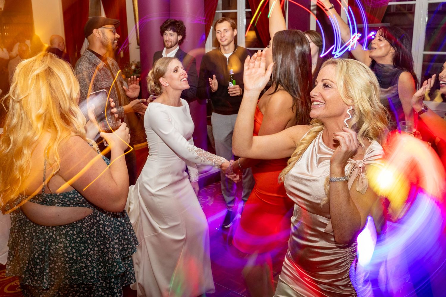 bride surrounded by her friends on the dancefloor at the Athenaeum, Liverpool city centre wedding reception venue Stuart Morris Photography