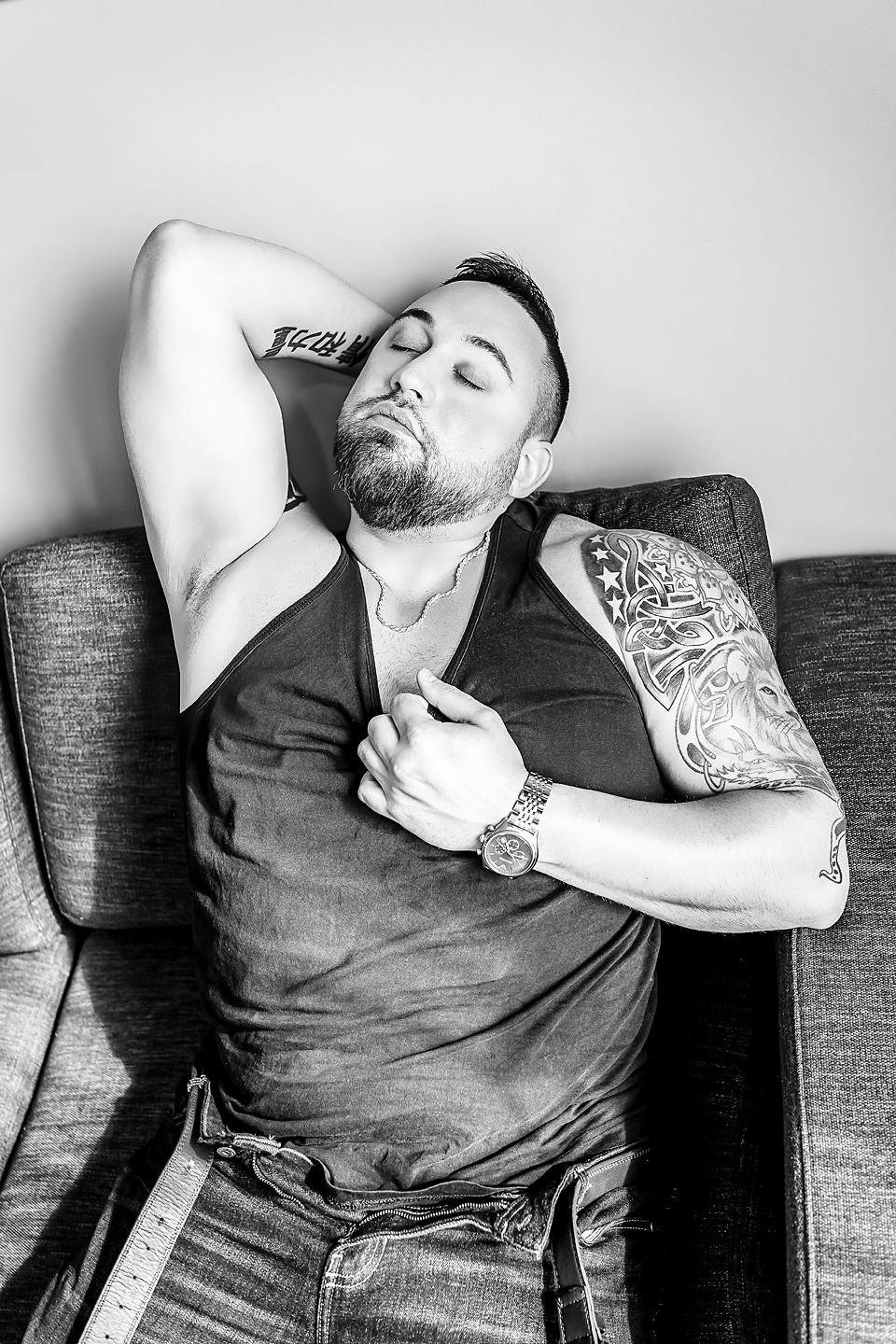 A progressive series of black and white shots showing someone reclining and relaxing on a sofa.