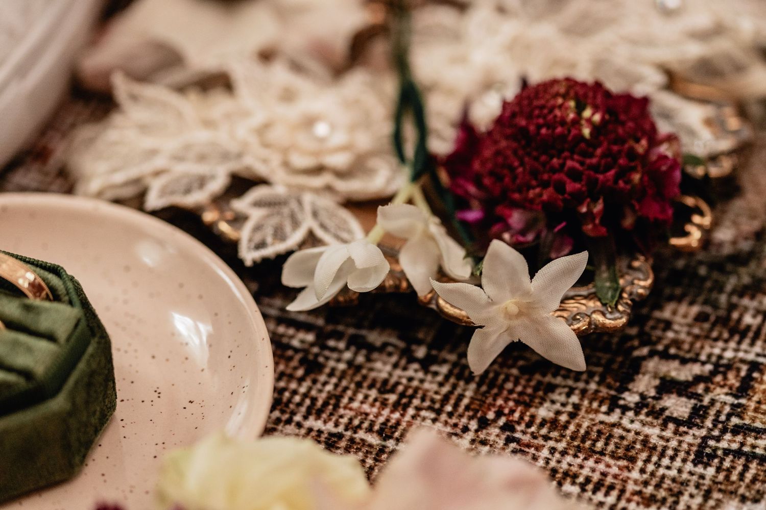 Delicate wedding flat lay with lace details, red and white florals, and gold tray—perfect bridal accessory styling for SEO wedding photos.