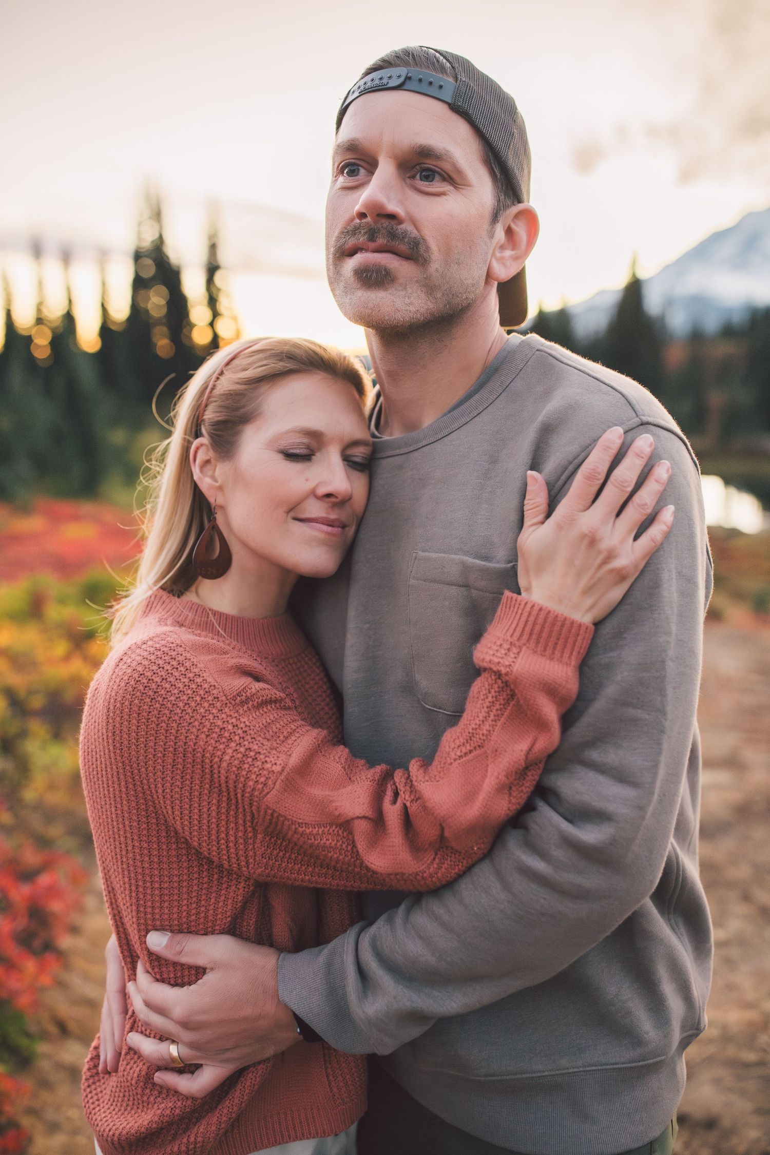 Husband and wife embracing during a family photoshoot in Mt. Rainier National Park in Washington