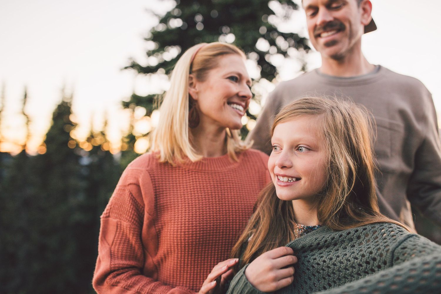 Mother father and daughter all smiling together during a family photoshoot in Mt. Rainier National Park in Washington