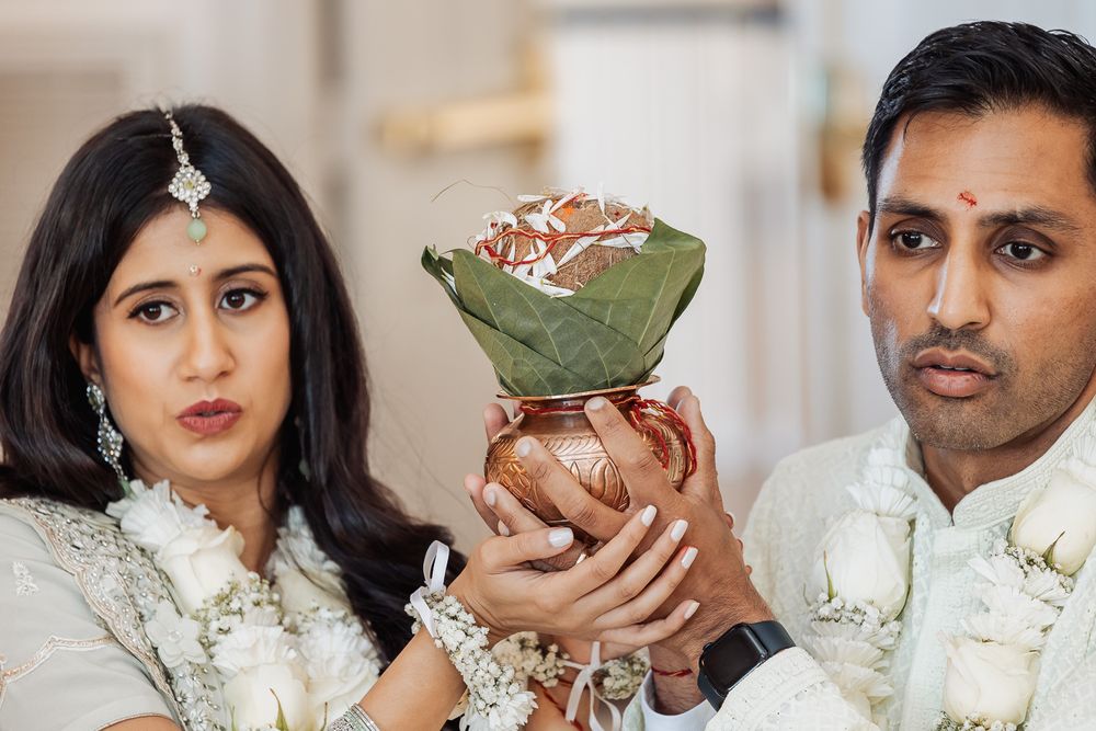 Traditional ceremony participants holding decorative offering wrapped in green leaf.