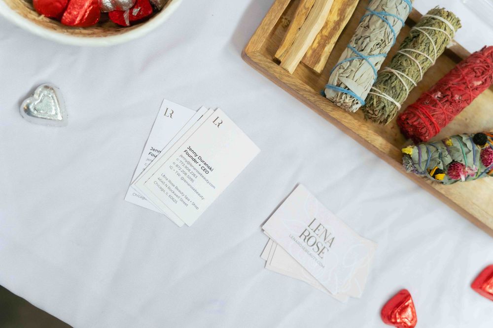 White tablecloth with scattered papers and decorative elements for an event setup. At Fairlie, Chicago