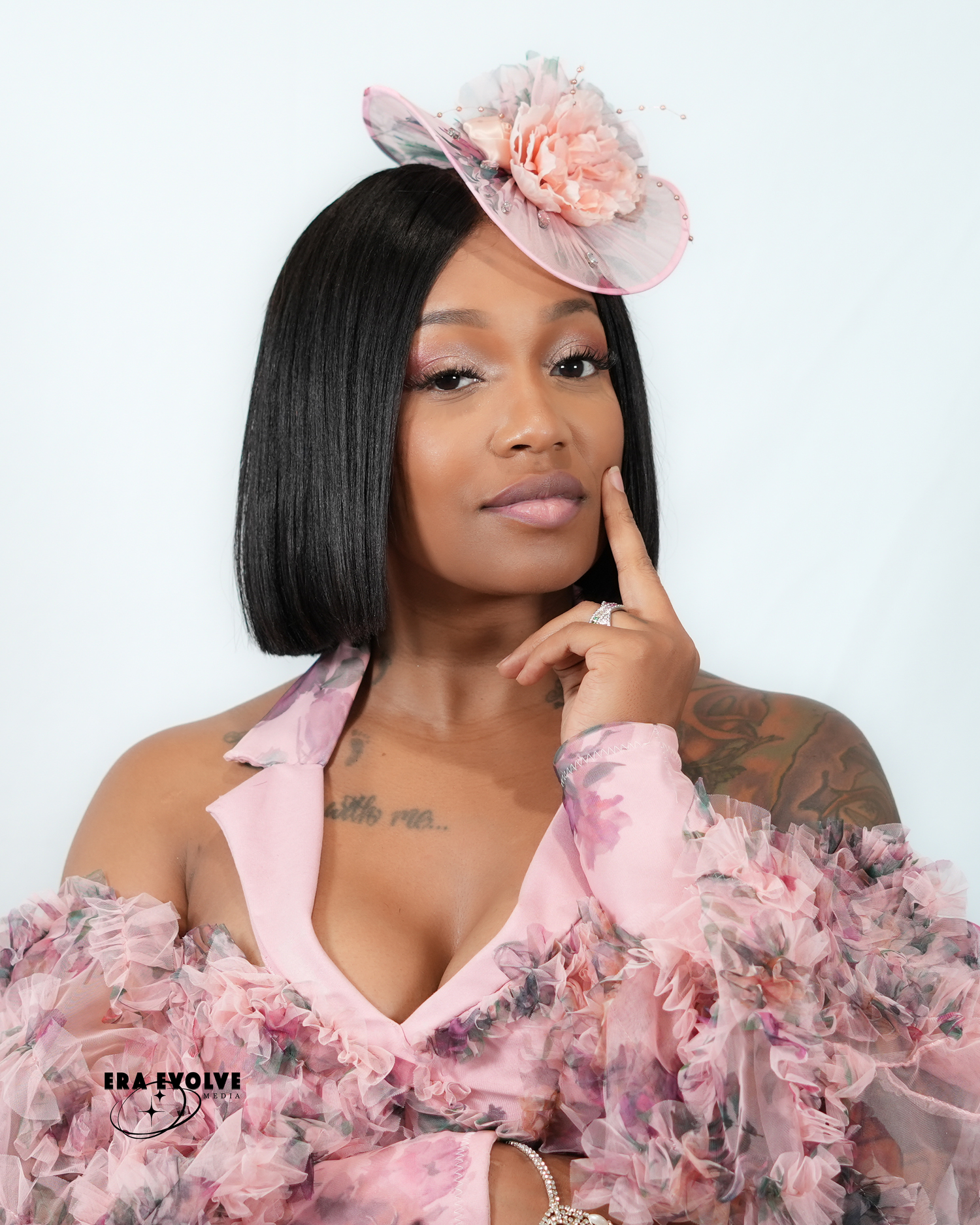 Black woman in a pink blouse posing for a headshot