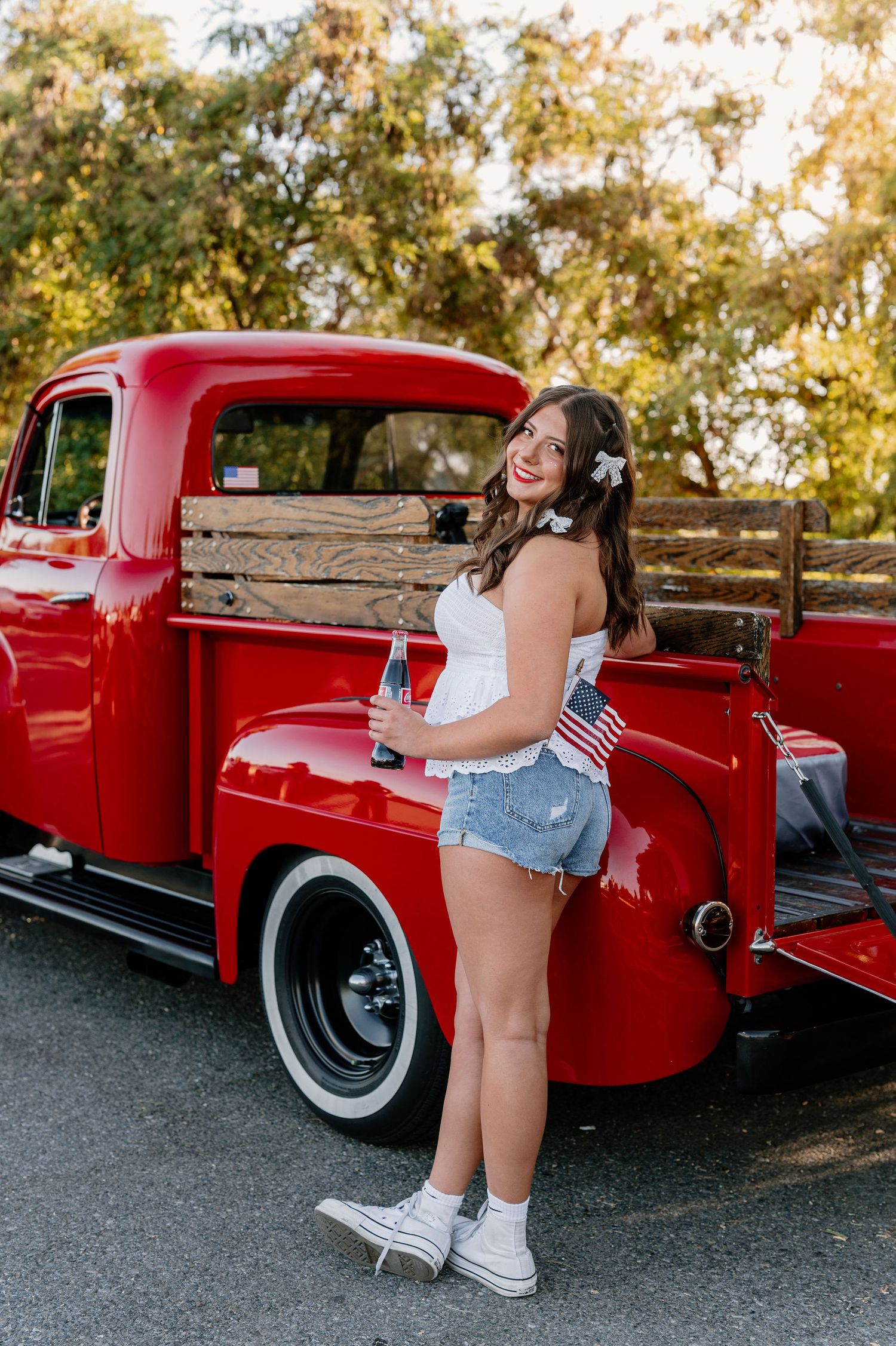 Patriotic senior pictures with a vintage red truck