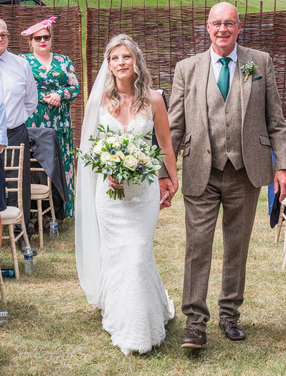 A bride & father-of-the-bride walking down the isle at Fort Henry wedding venue in Oakham with a flowing white wedding dress