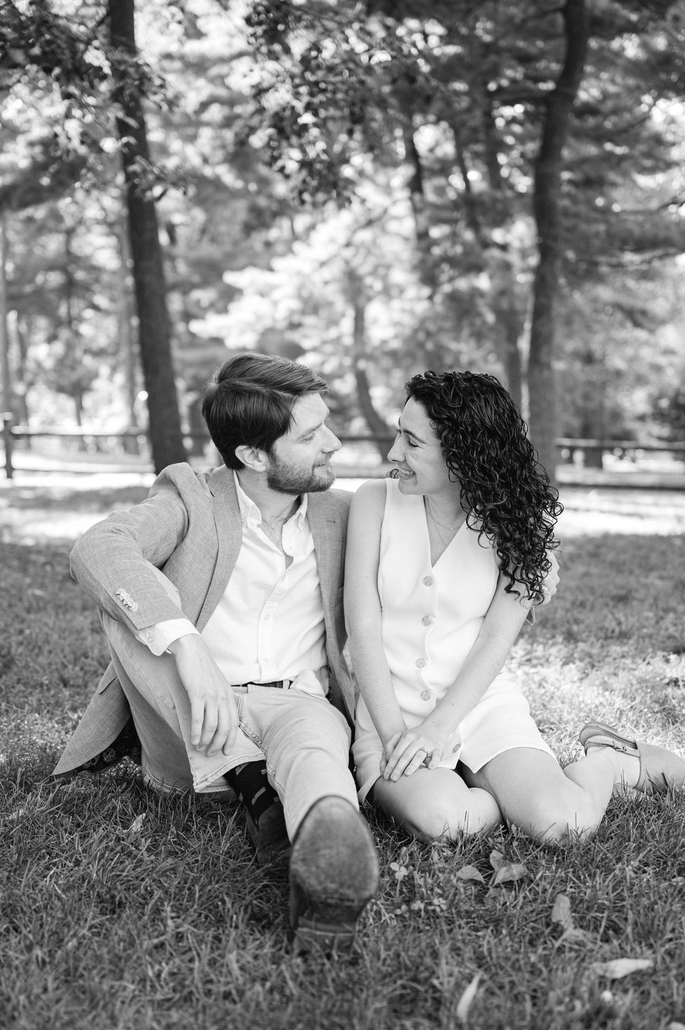 A black and white photo of a couple sharing a romantic moment in Central Park during their engagement session by Joliette Marie Photography.