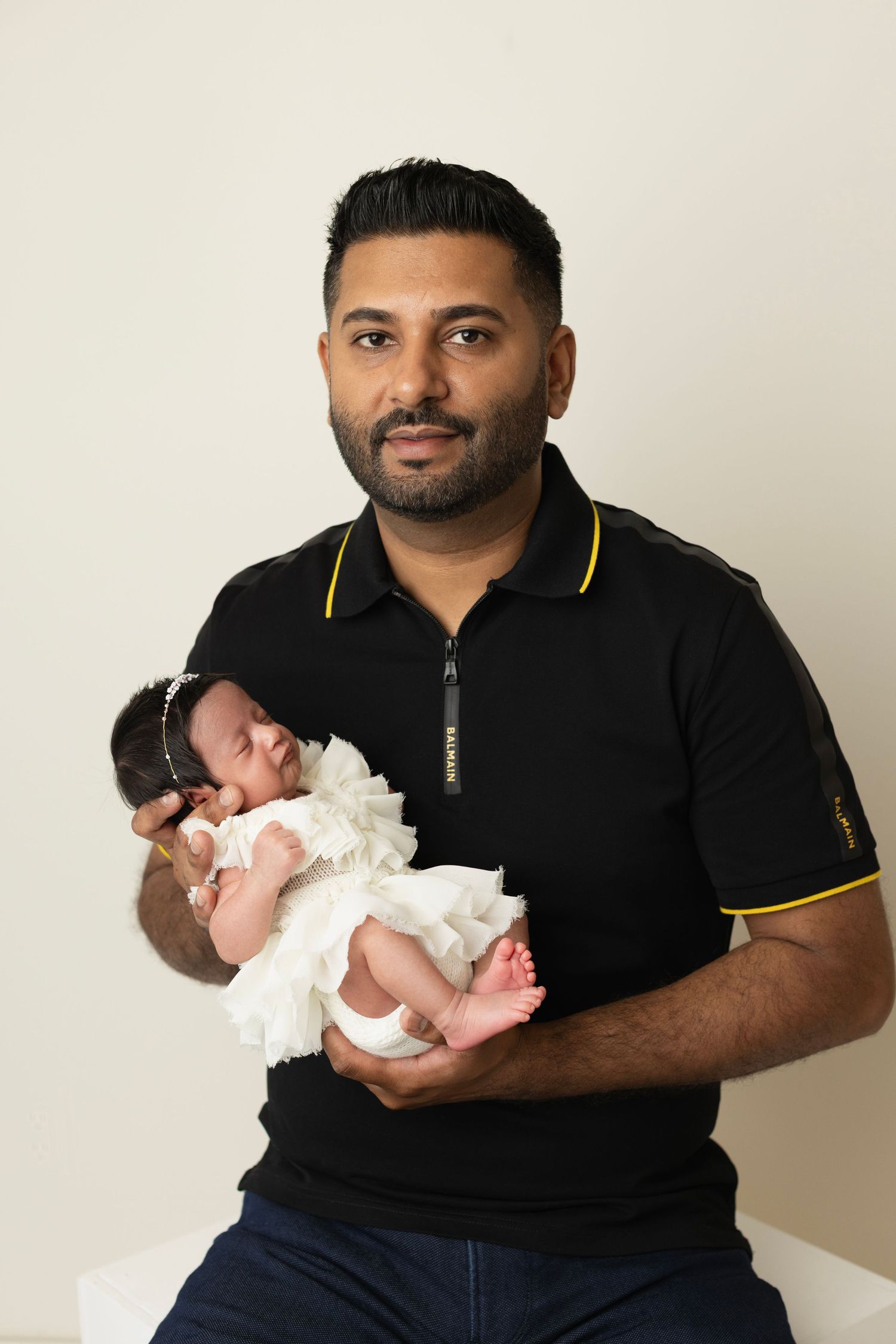 Elizabeth Lang Photography. Twin newborn photography Surrey. Dad holds his daughter