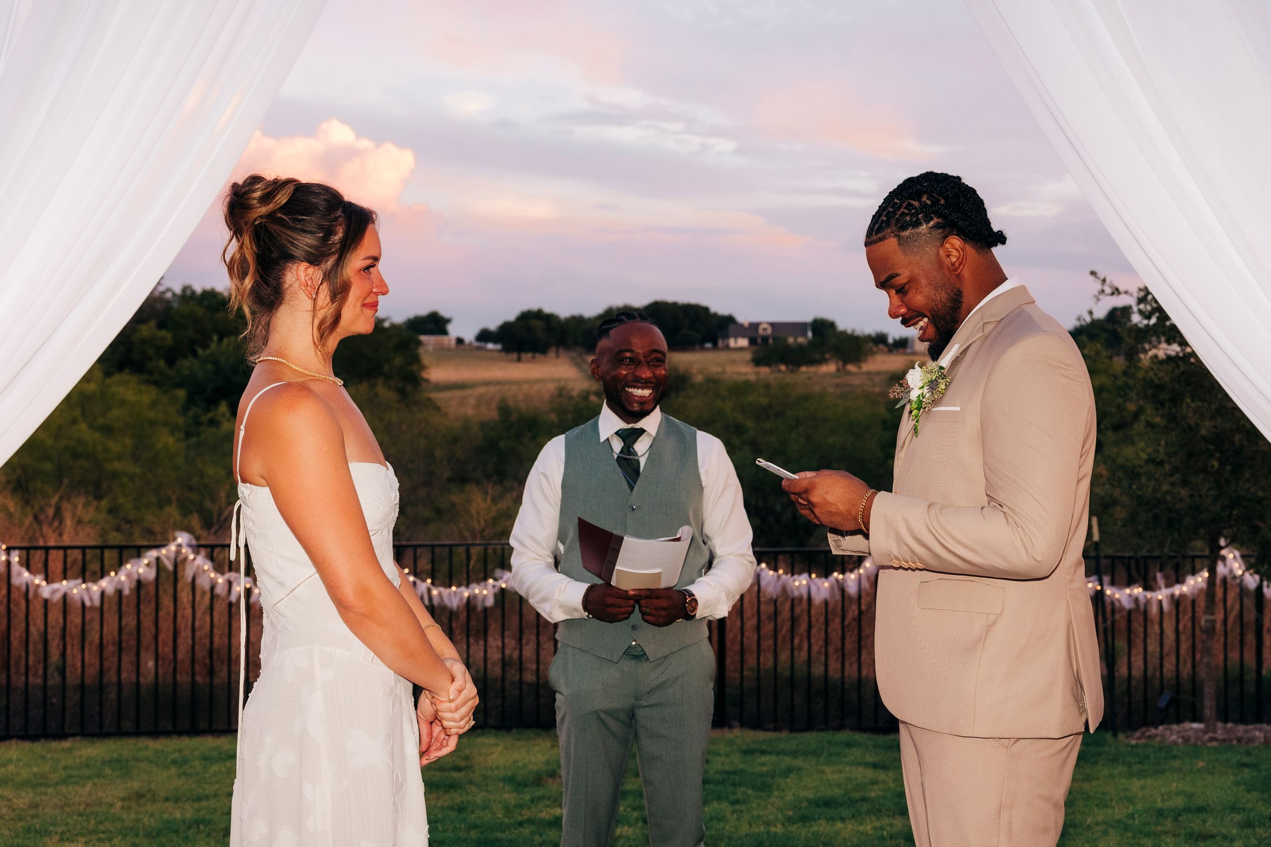 Outdoor backyard ceremony under string lights at a small Fort Worth wedding
