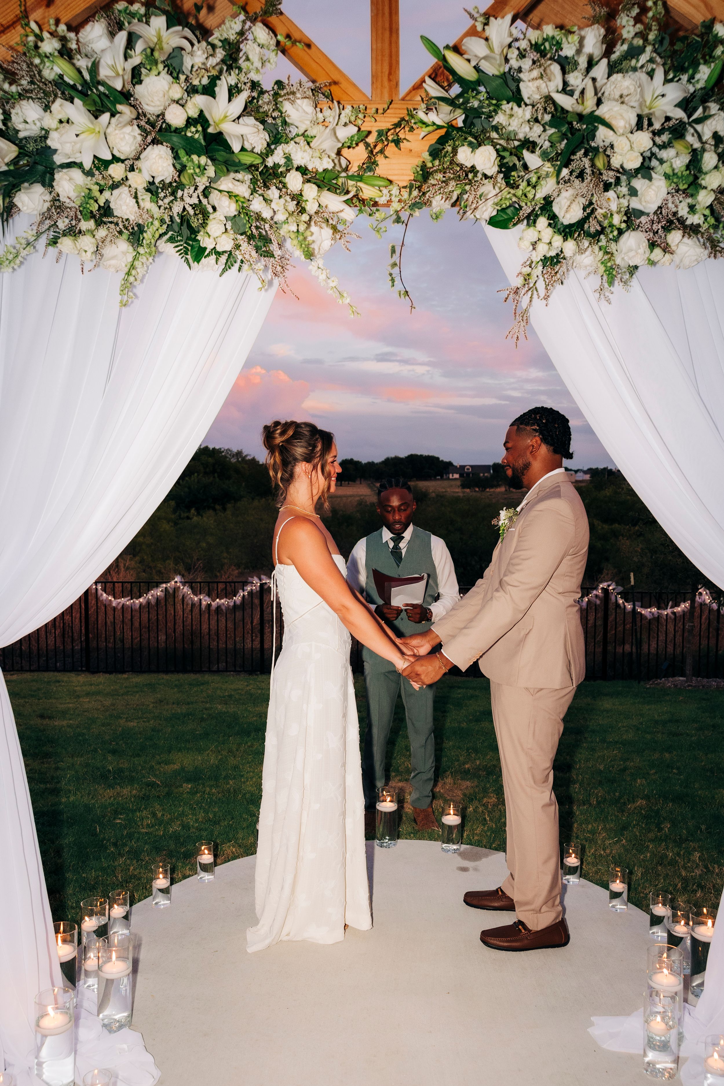 Outdoor backyard ceremony under string lights at a small Fort Worth wedding