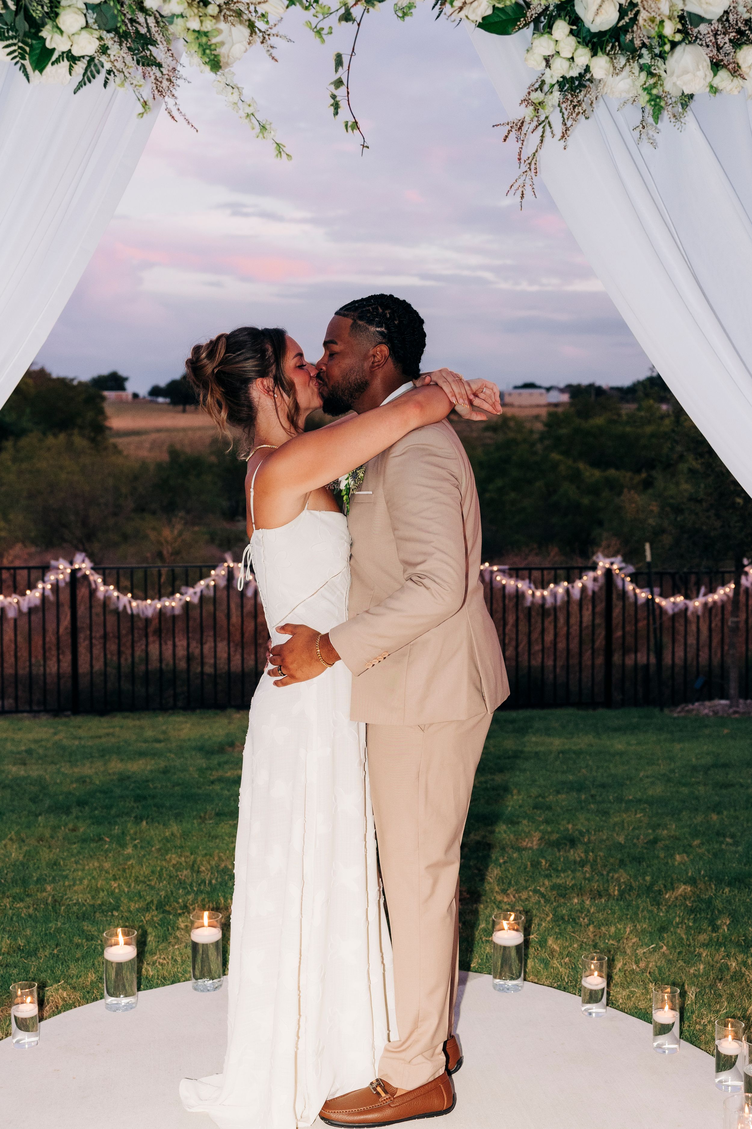 Outdoor backyard ceremony under string lights at a small Fort Worth wedding