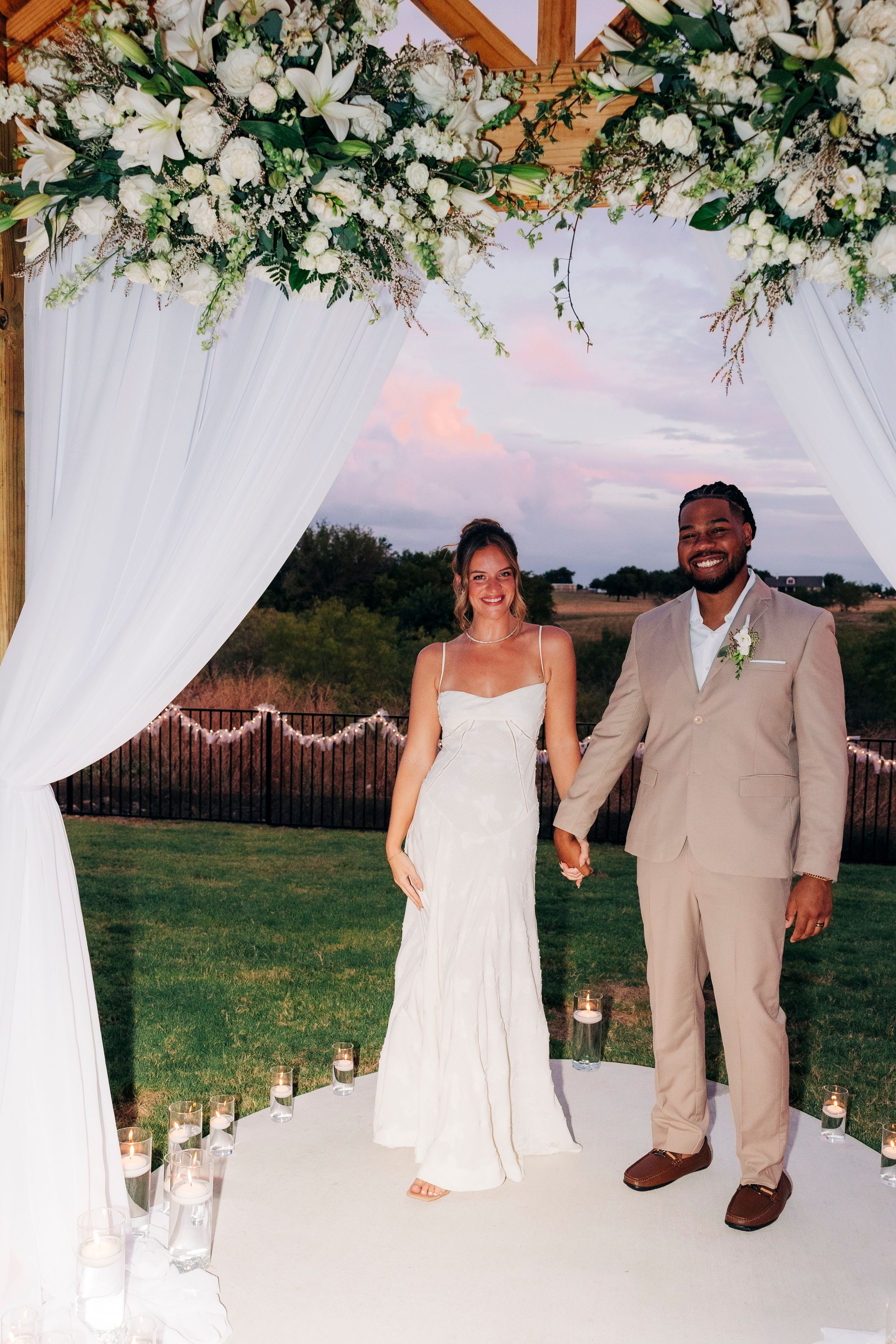 Outdoor backyard ceremony under string lights at a small Fort Worth wedding