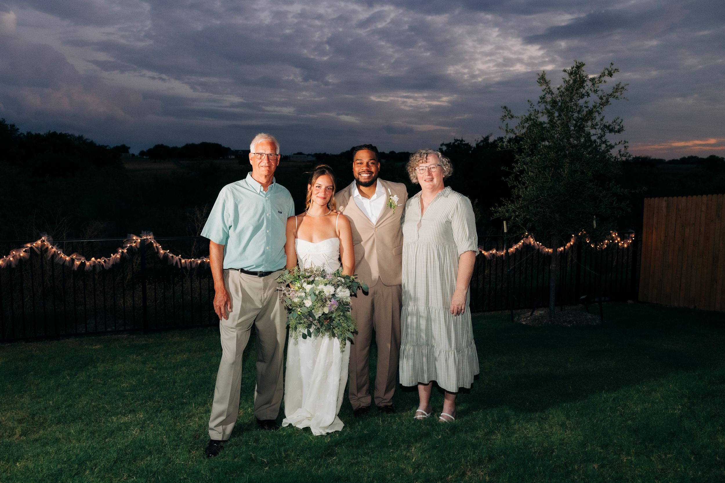 Full family portrait after outdoor backyard ceremony at summer wedding in Fort Worth, Texas
