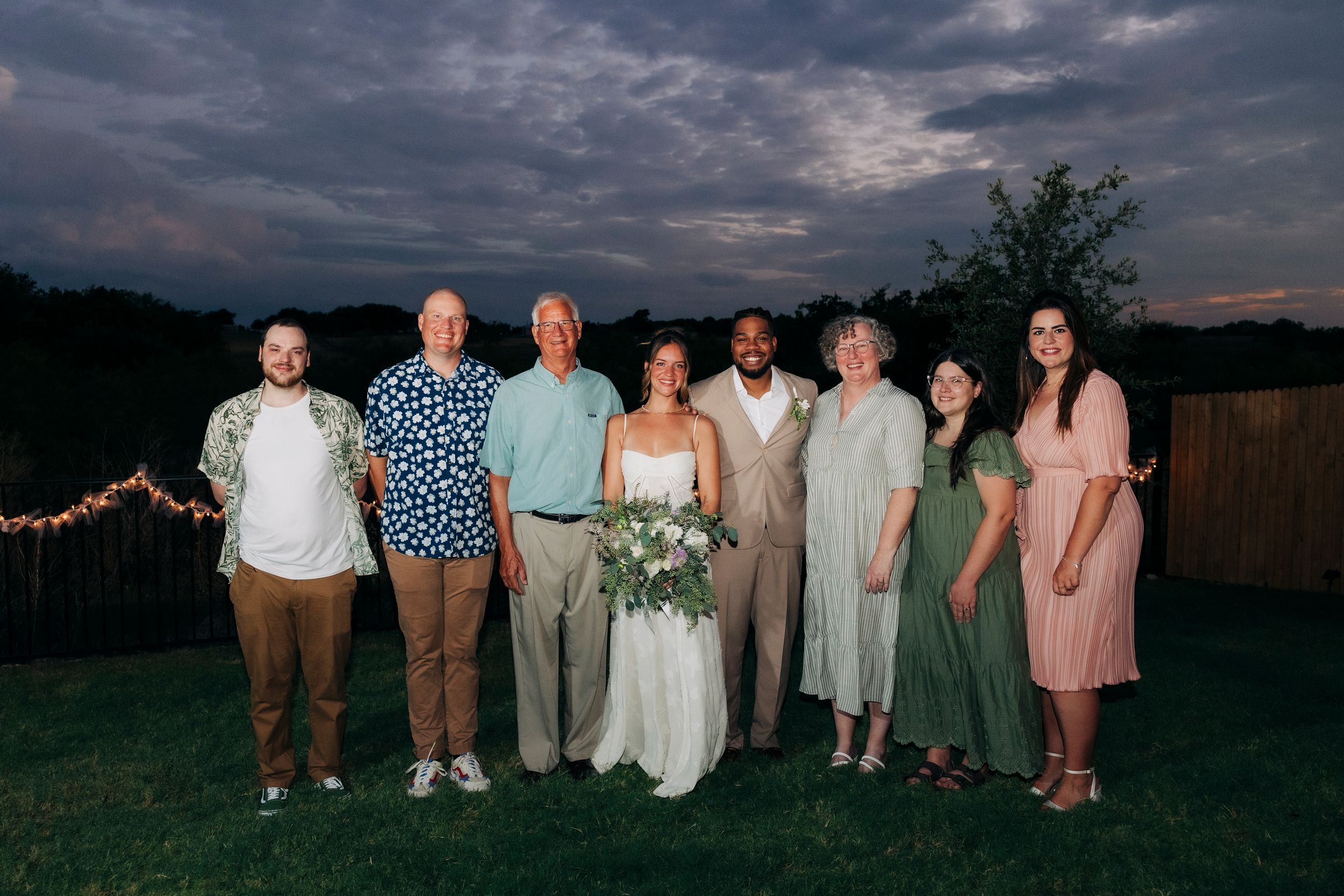 Full family portrait after outdoor backyard ceremony at summer wedding in Fort Worth, Texas