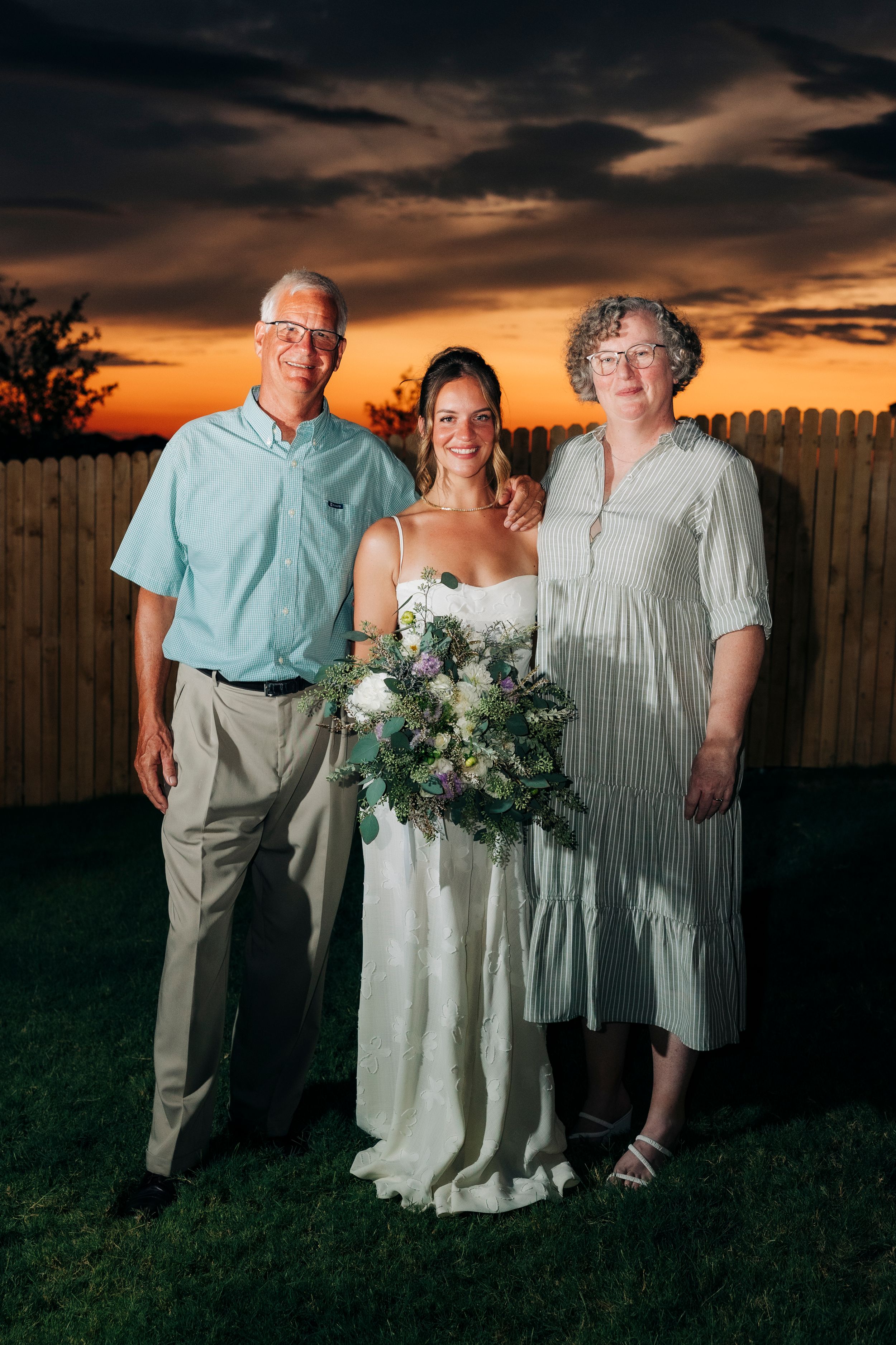 Full family portrait after outdoor backyard ceremony at summer wedding in Fort Worth, Texas