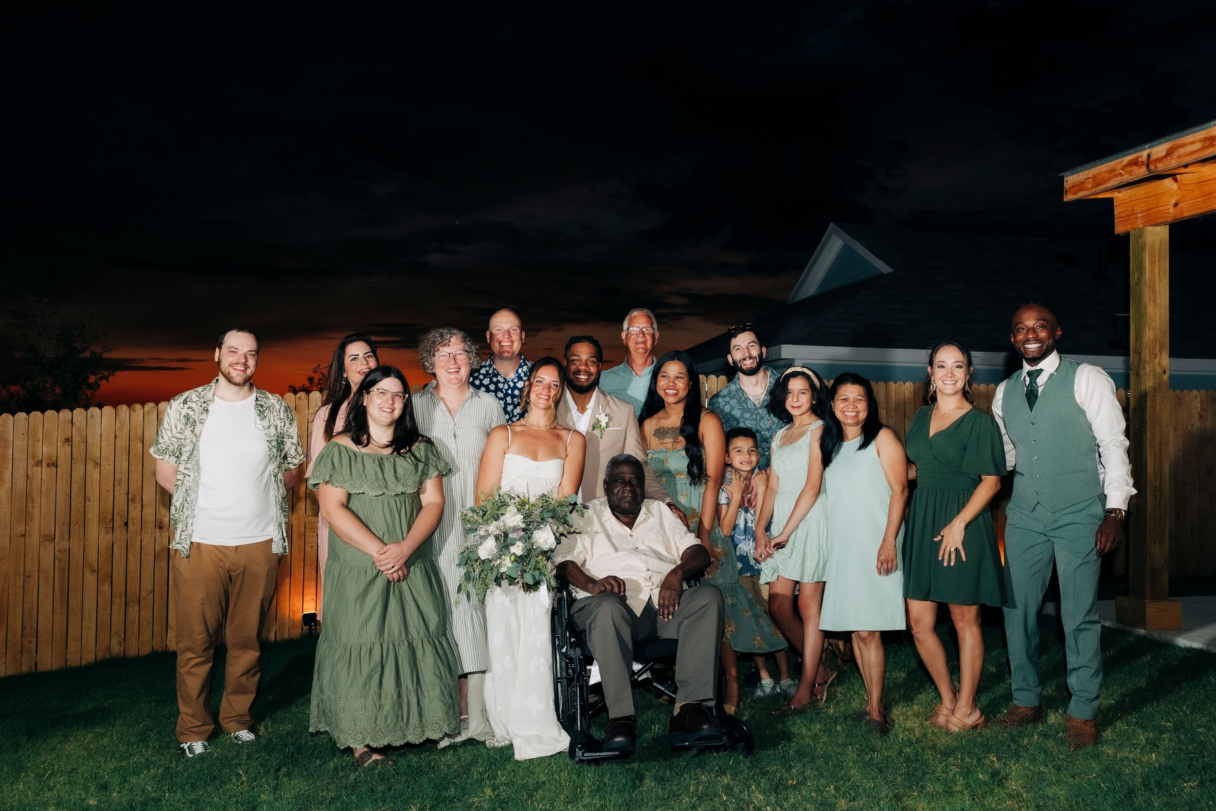 Full family portrait after outdoor backyard ceremony at summer wedding in Fort Worth, Texas
