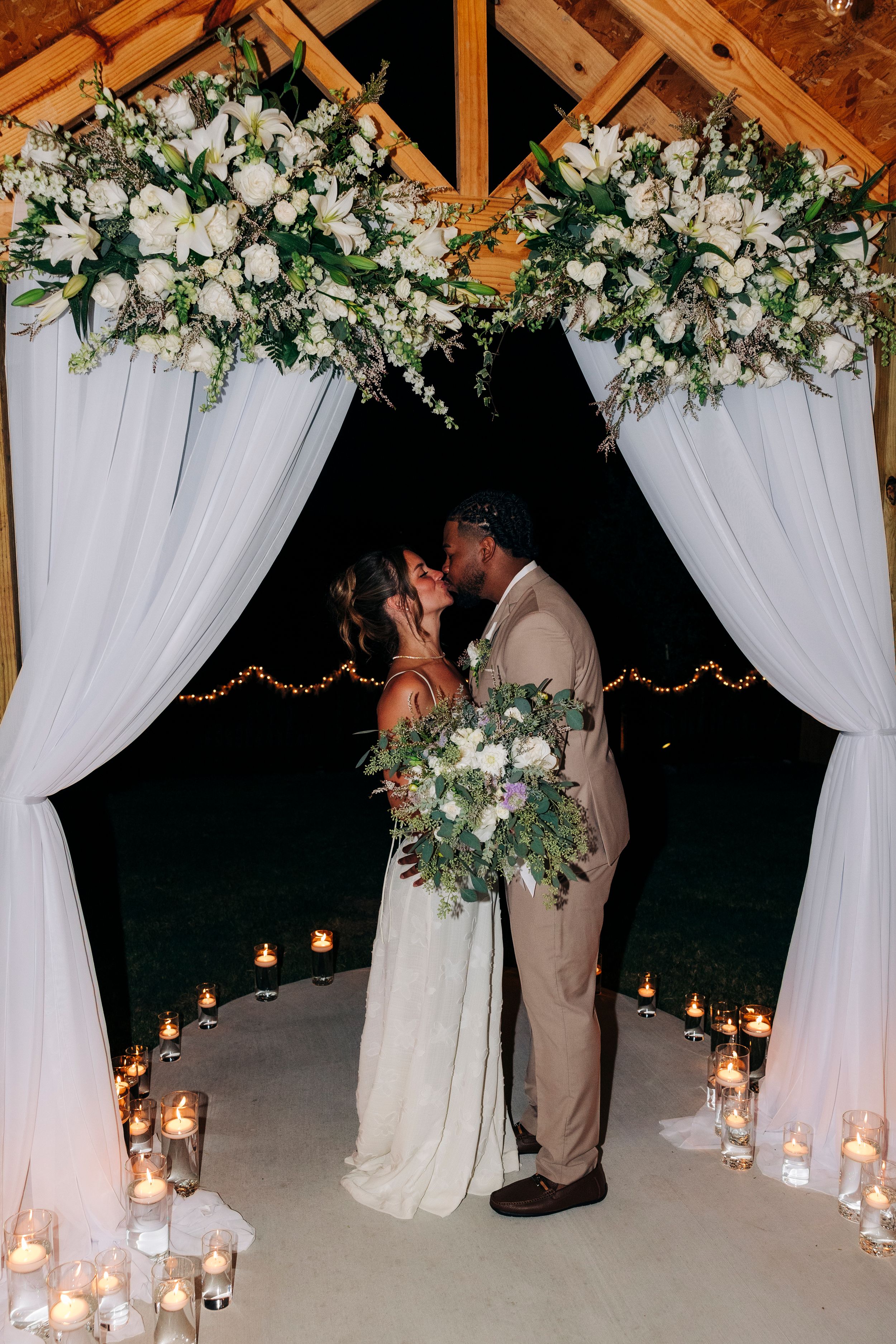 Bride and groom smiling at each other during golden hour at backyard summer wedding in Fort Worth, Texas