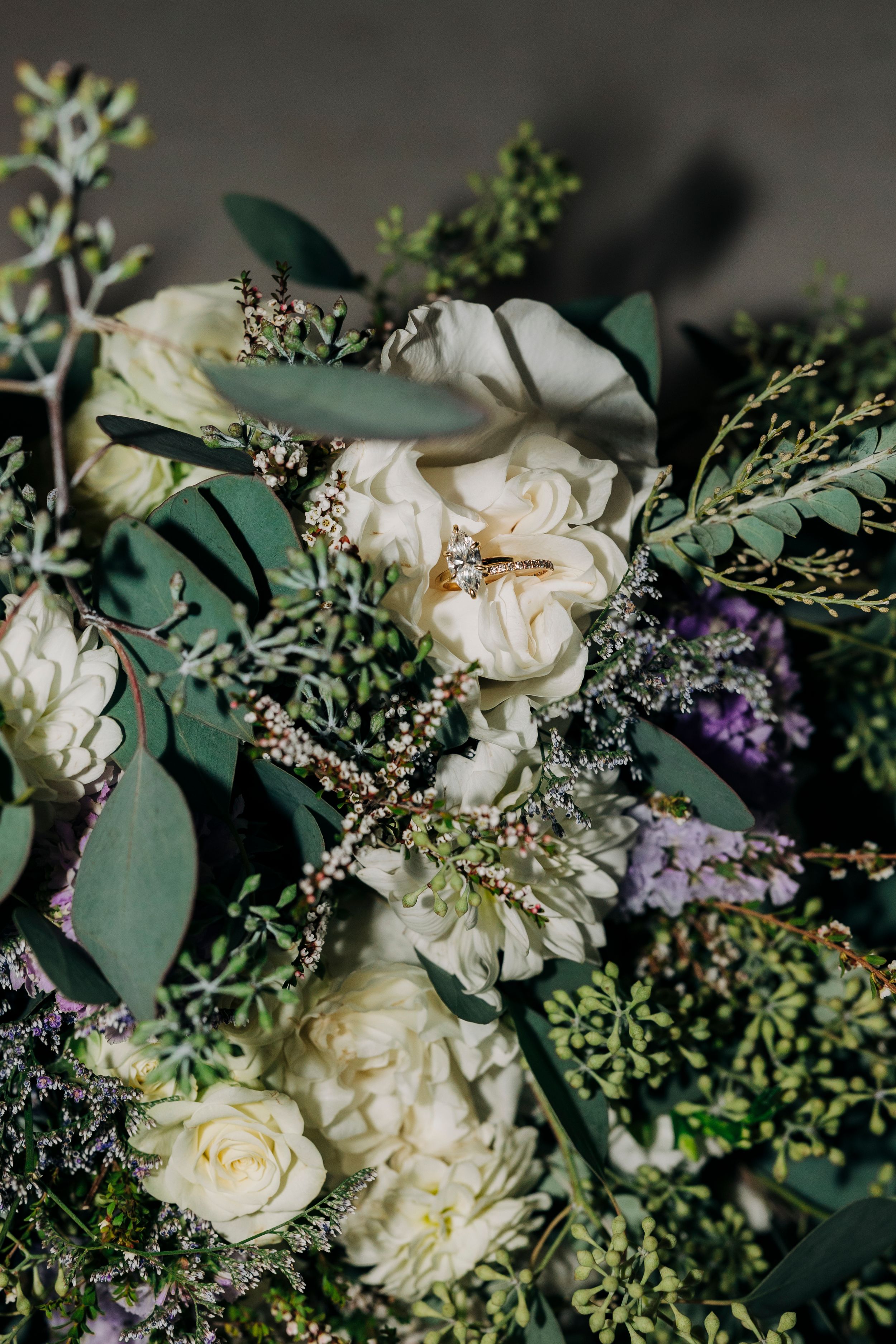 Bride holding white floral and greenery bouquet at backyard summer wedding in Fort Worth, Texas