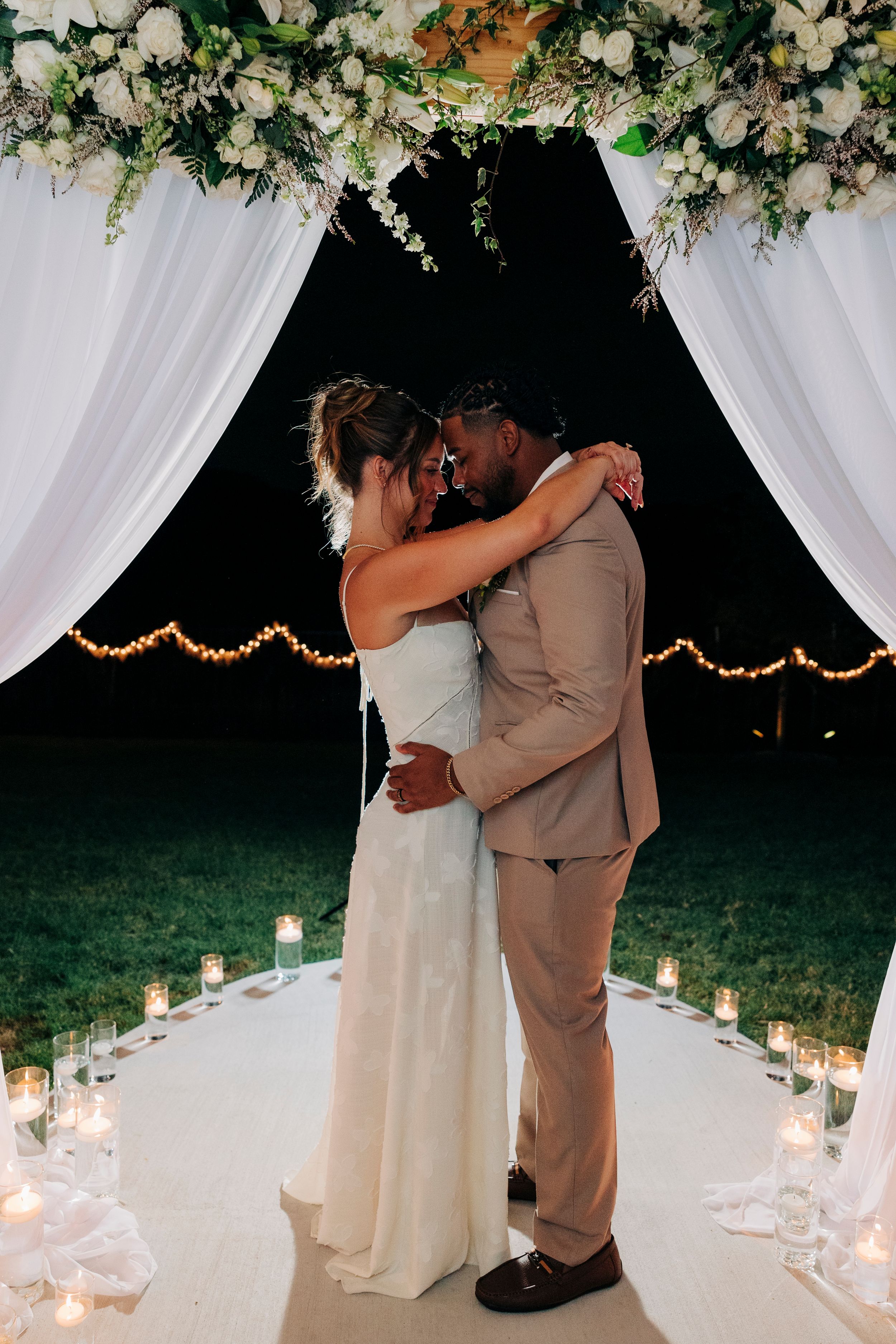 Bride and groom smiling at each other during golden hour at backyard summer wedding in Fort Worth, Texas