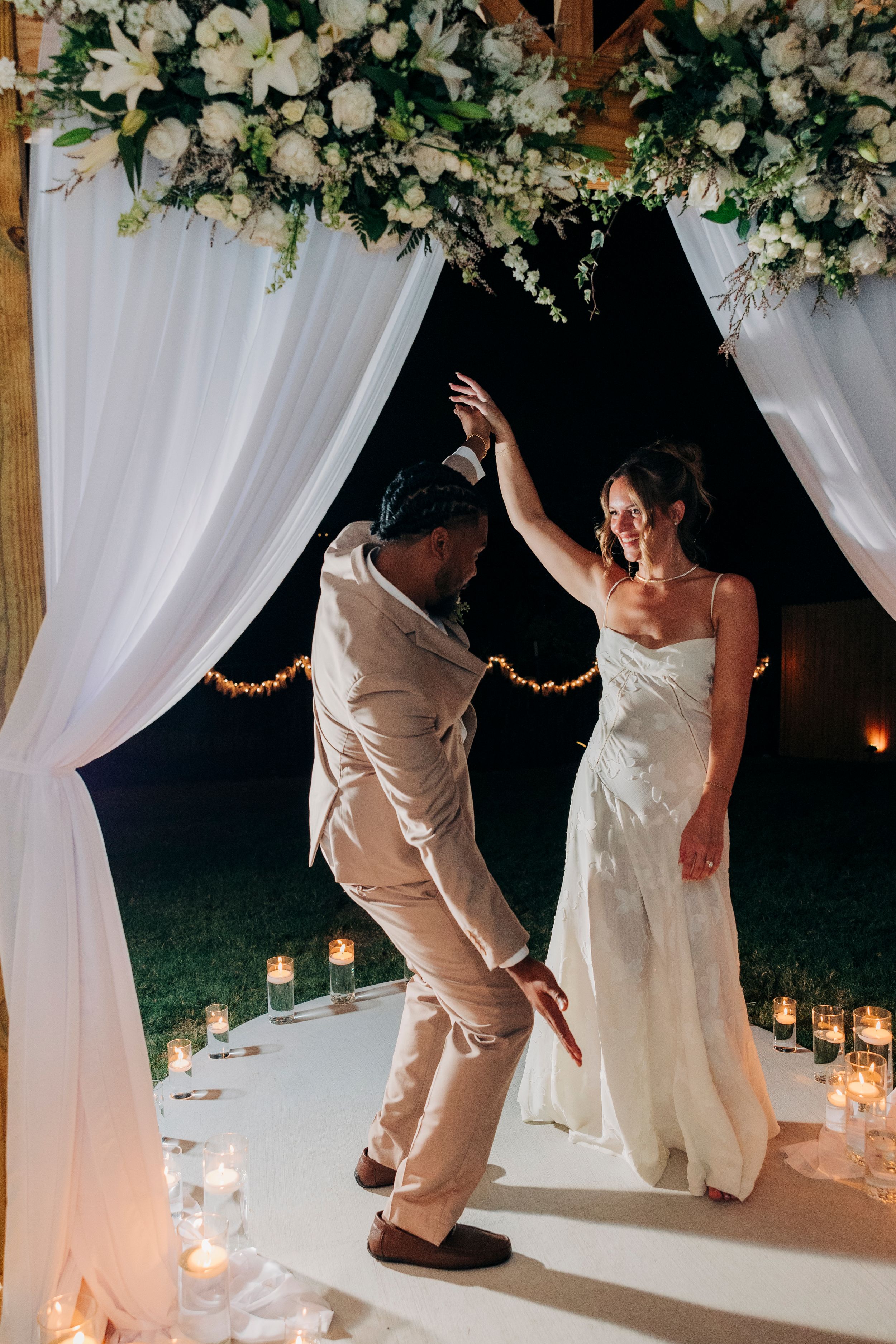 Bride and groom smiling at each other during golden hour at backyard summer wedding in Fort Worth, Texas