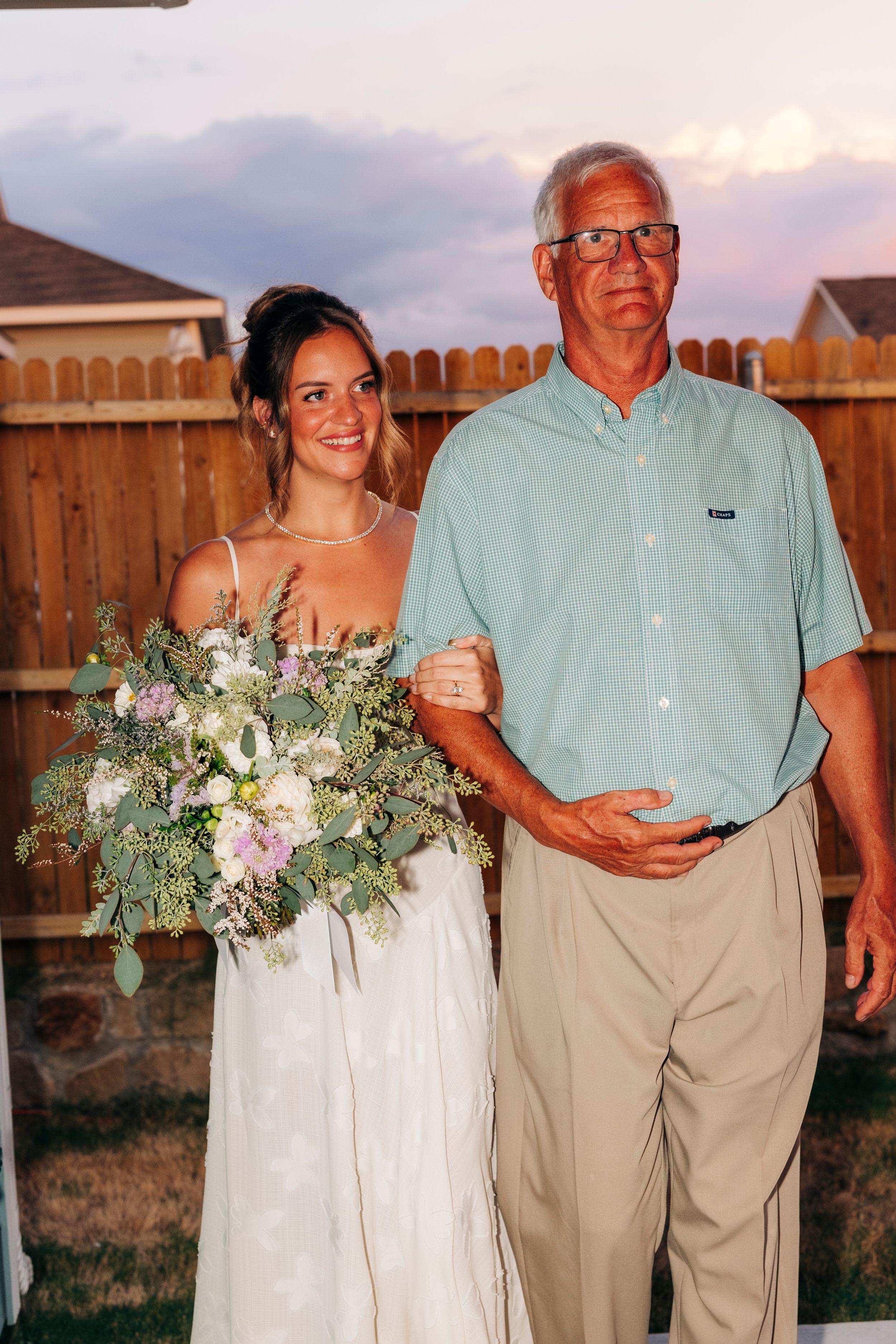 Bride walking down the aisle at a backyard summer wedding in Fort Worth, Texas during golden hour