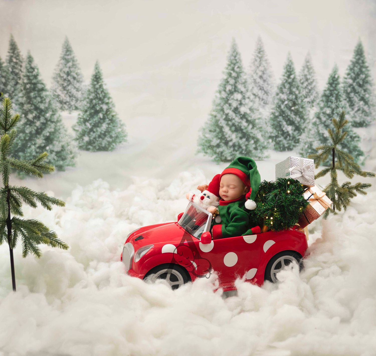 Red polka dot toy car carrying Christmas tree through snowy winter forest scene.