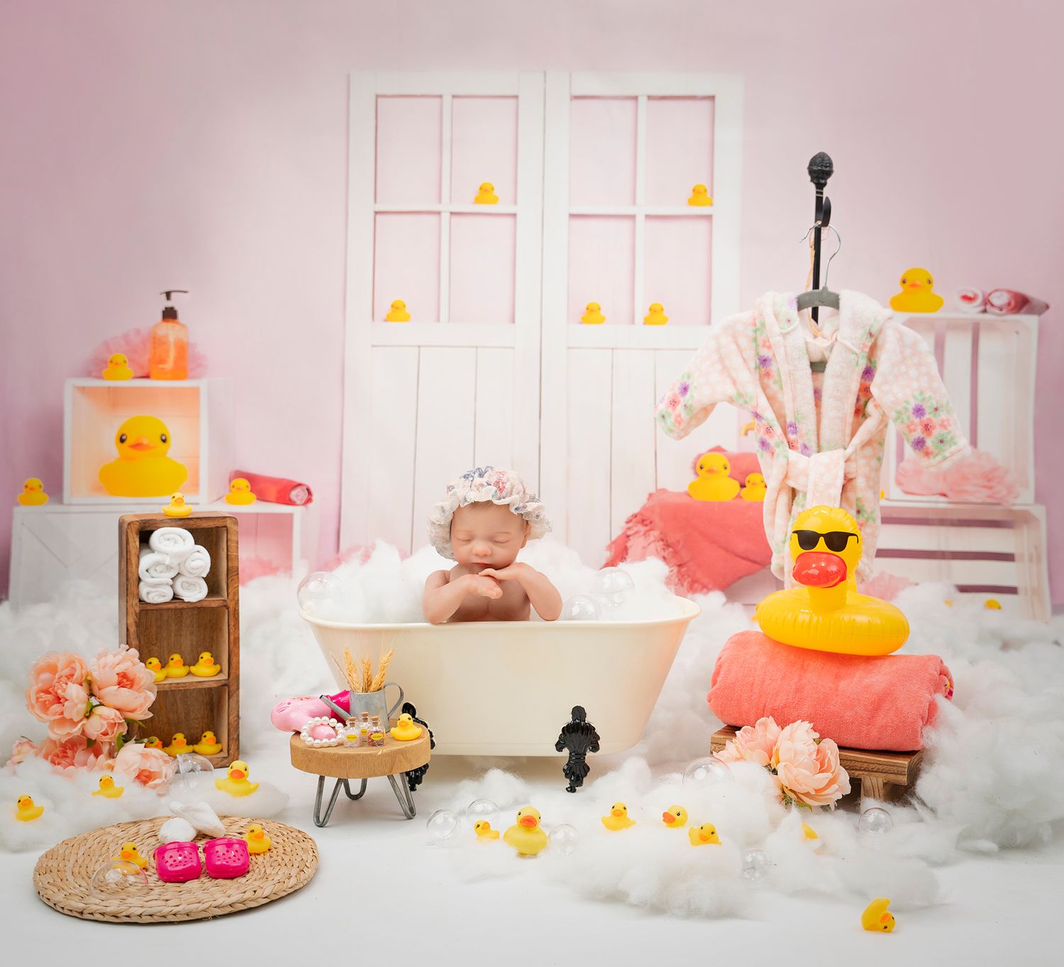 Vintage-style bathtub photo setup with rubber ducks, flowers, and dreamy pink decor.