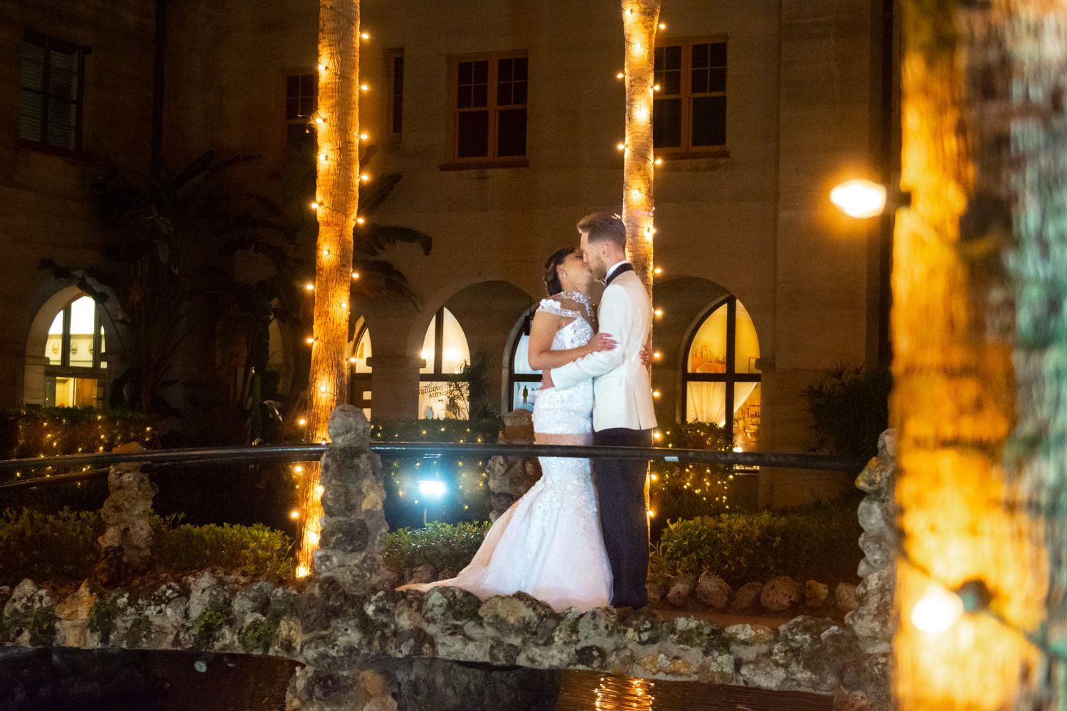 Candid portrait of a couple walking down a cobblestone street in St. Augustine’s historic district, framed in golden light.