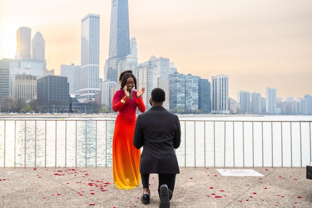 A couple shares a romantic moment at a railing overlooking the Chicago skyline during sunset.