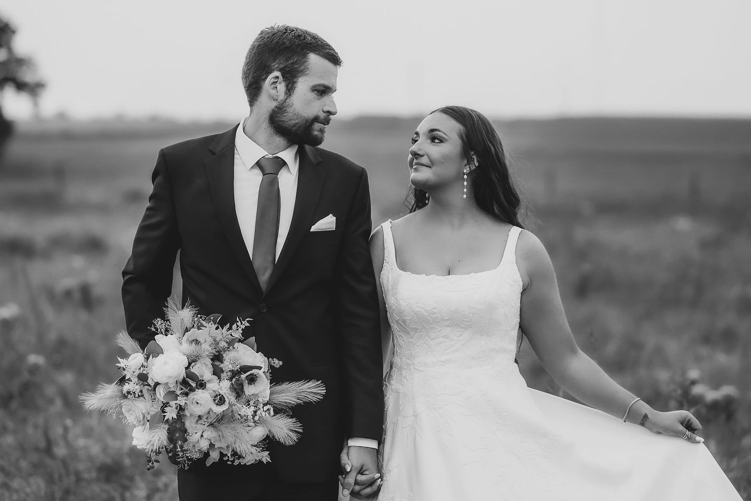 a lovely black and white portrait of a bride and groom gazing lovingly at each other during their formal photos taken by april pinto