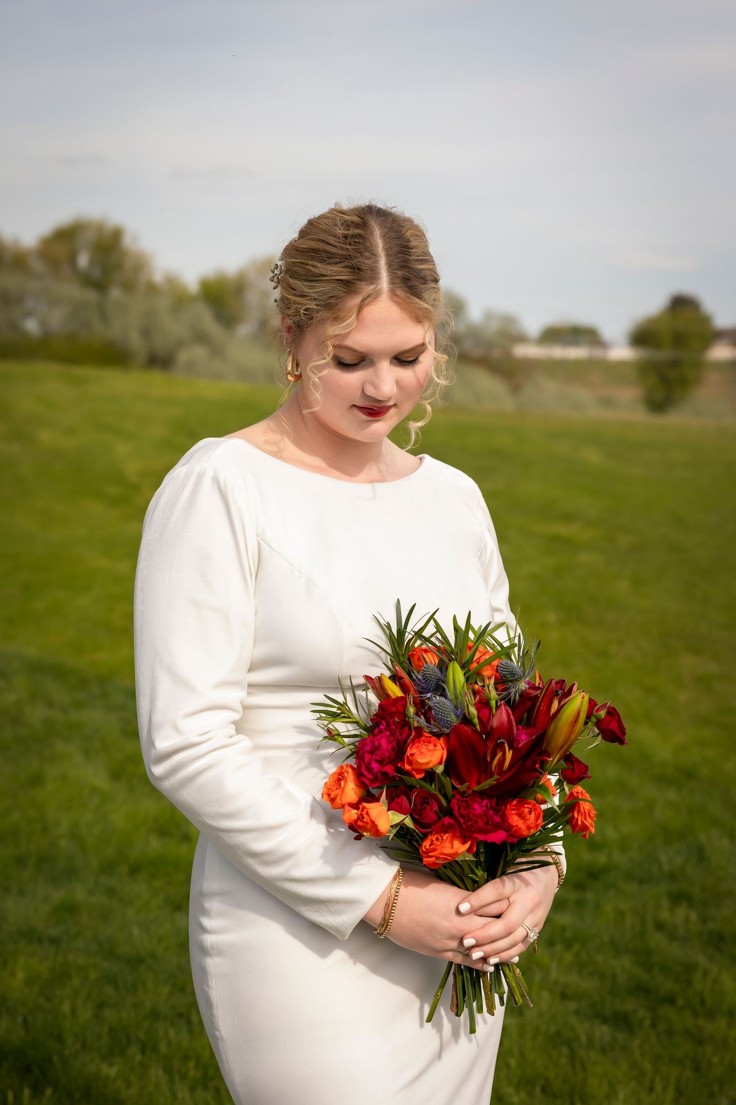 Bride looking at bouquet at Garman Hill
