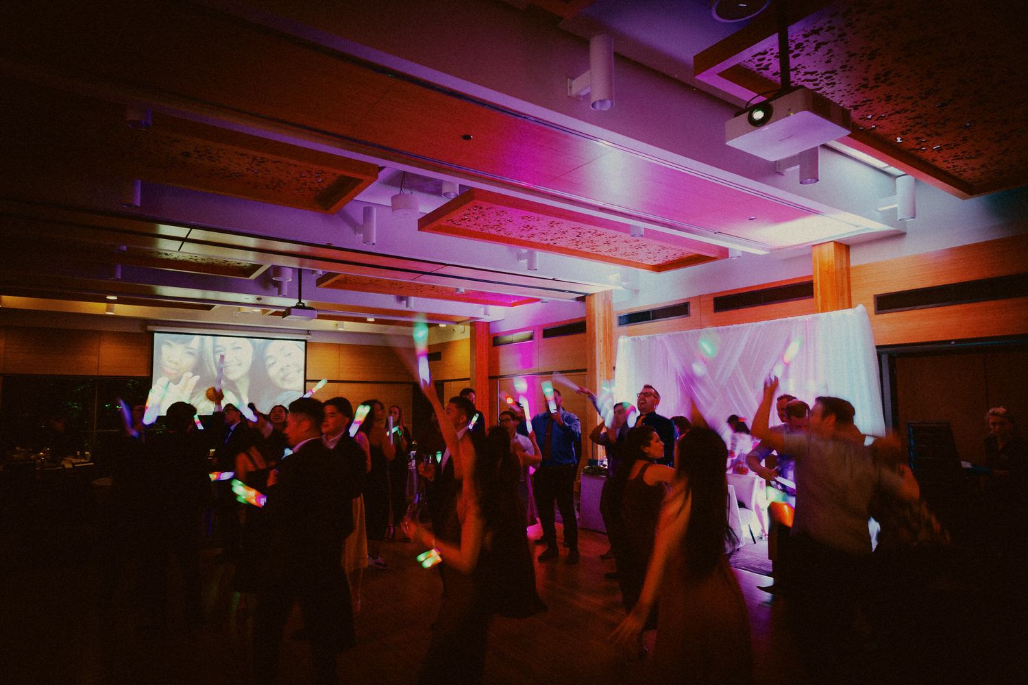 Candid moments of laughter and dancing during a Calgary wedding reception, photographed by a Calgary wedding photographer.