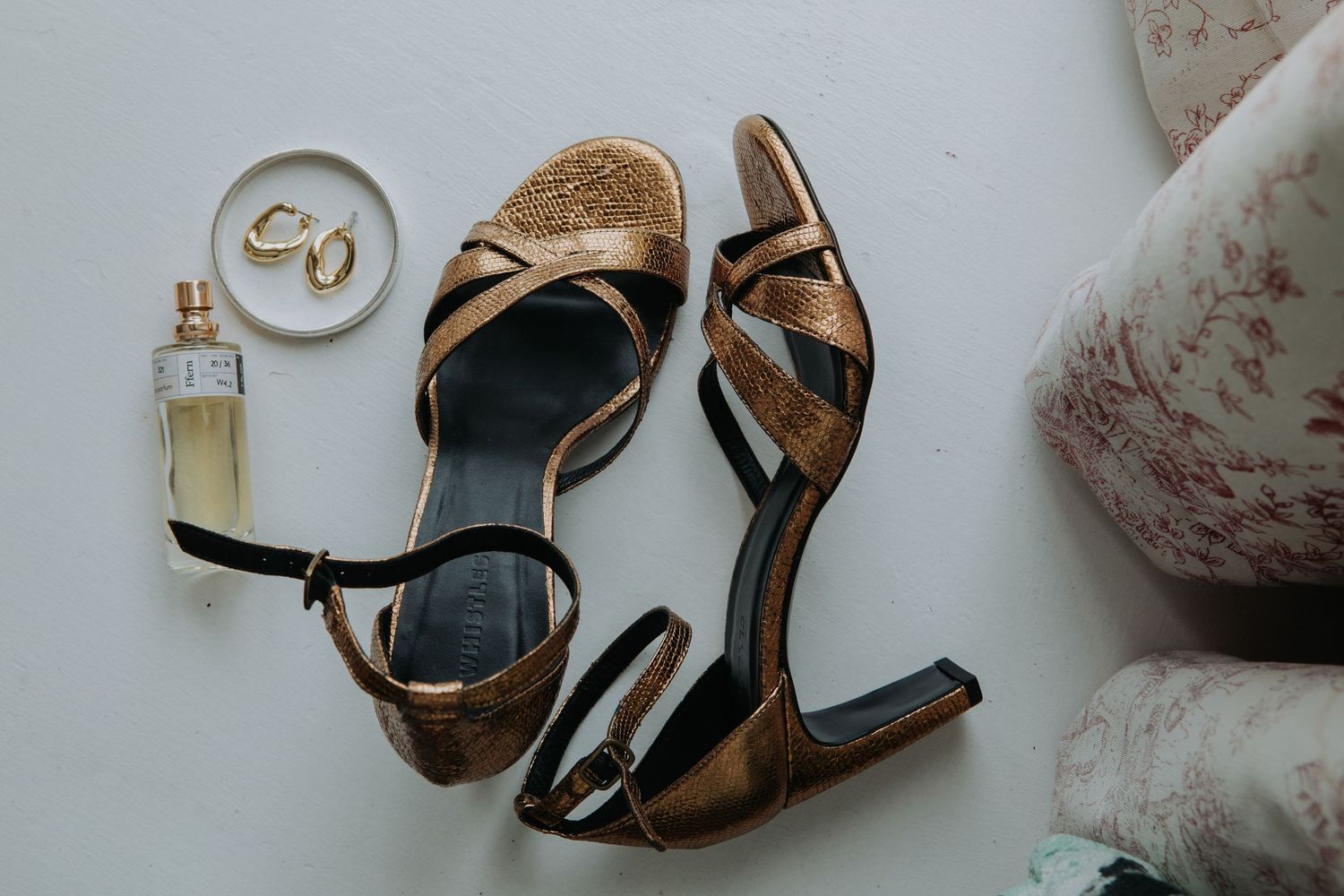 Rows of vintage leather and canvas shoes displayed artistically on white surface with subtle shadows and textures.