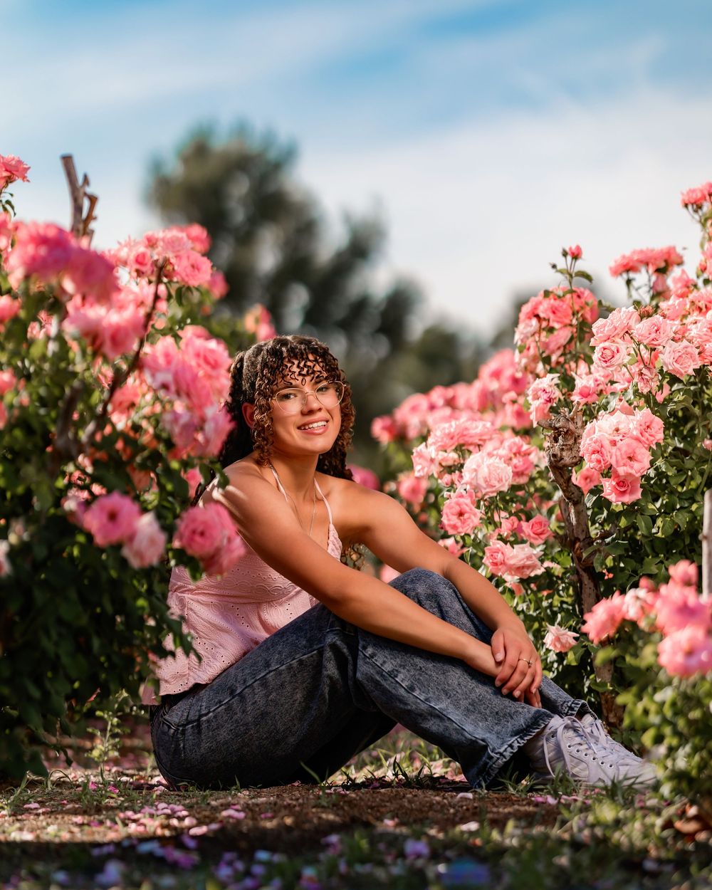 Senior portrait of girl surrounded by roses, Tucson rose garden