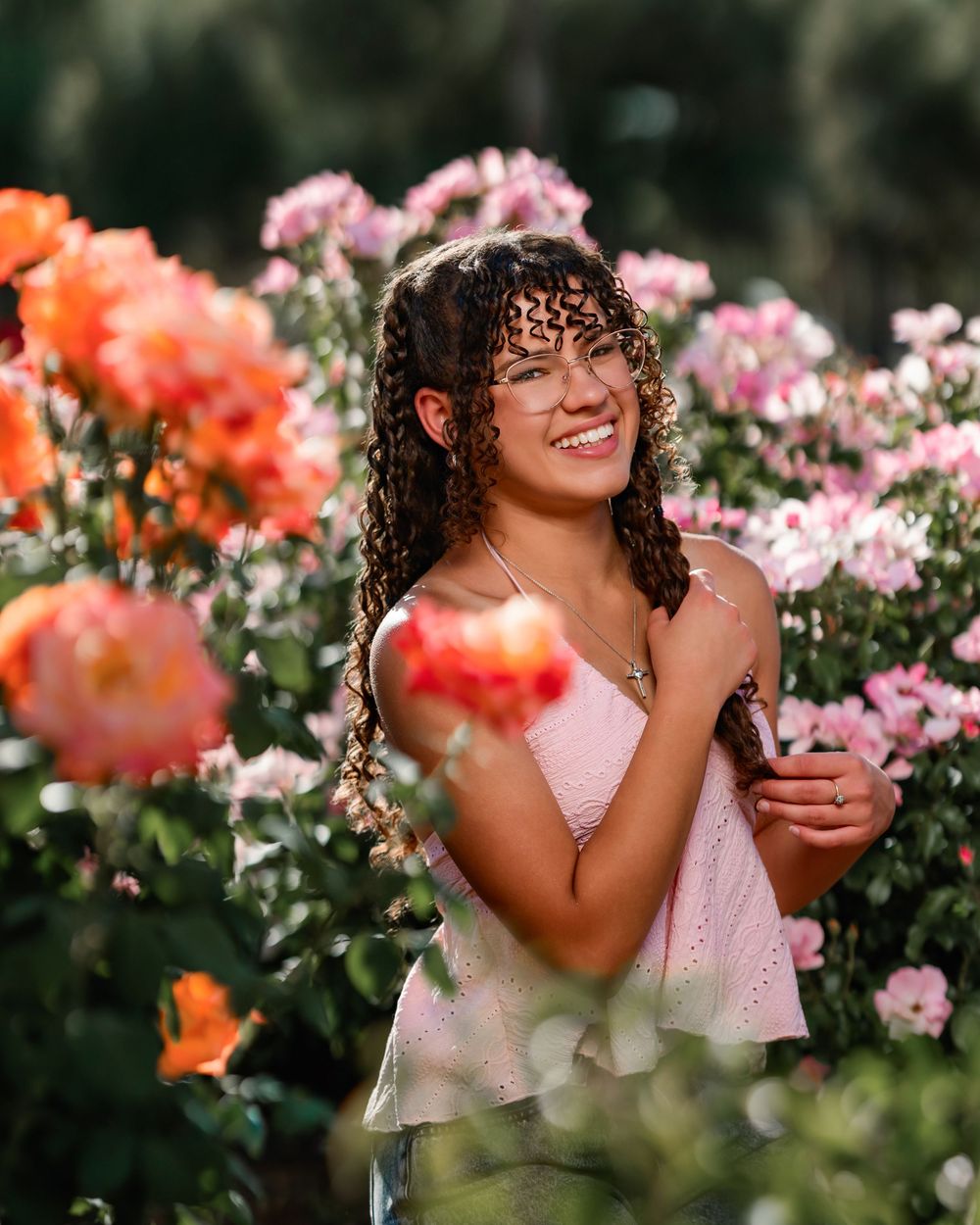 Senior portrait of girl surrounded by roses, Tucson rose garden