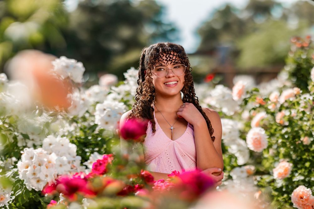 Senior portrait of girl surrounded by roses, Tucson rose garden
