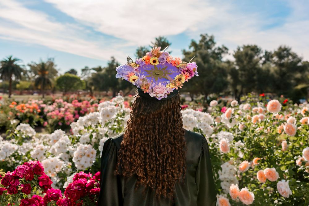 Senior portrait of girl surrounded by roses, Tucson rose garden