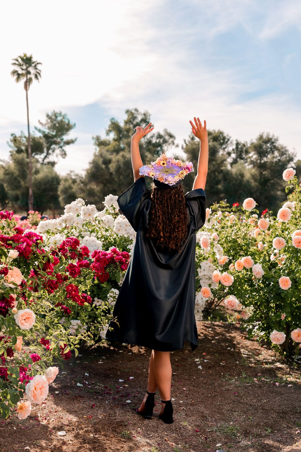 Senior portrait of girl surrounded by roses, Tucson rose garden
