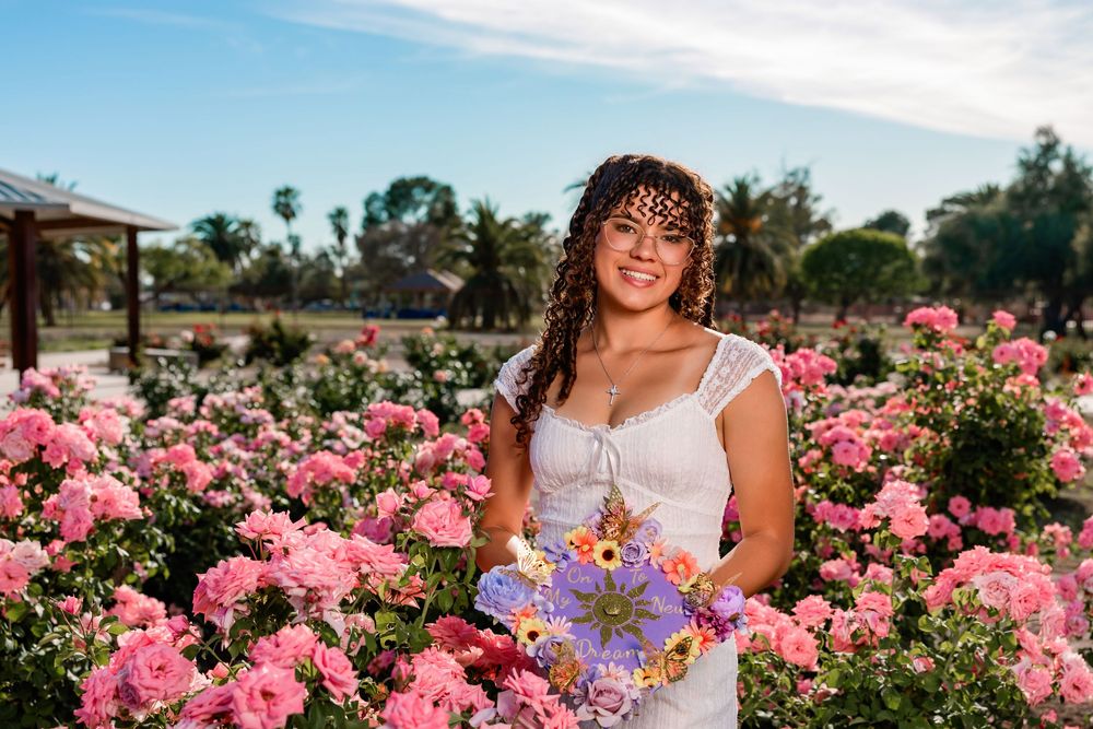 Senior portrait of girl surrounded by roses, Tucson rose garden