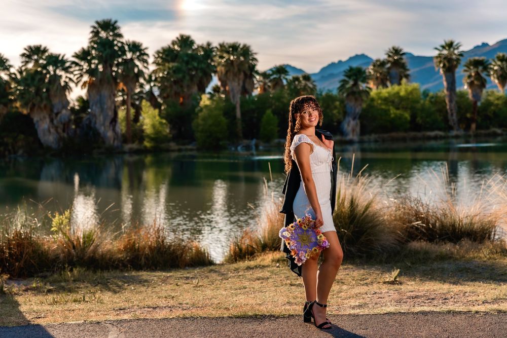 Senior portrait of girl surrounded by roses, Tucson rose garden