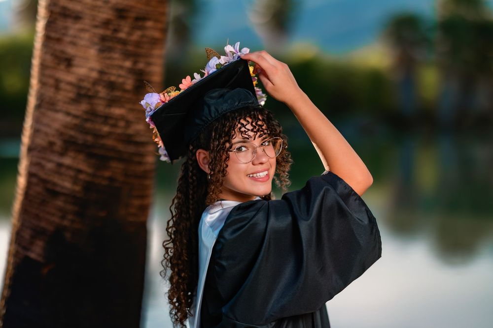 Golden hour senior photo at Agua Caliente Park with palm trees and pond, Tucson, AZ Senior pictures